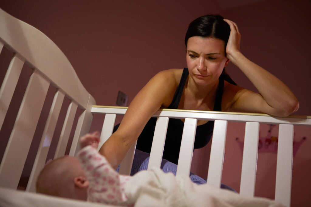 A frustrated mum trying to put the baby at sleep